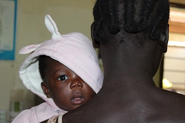 Mother with her child seeking treatment at a Health Centre in Kisumu, Kenya 